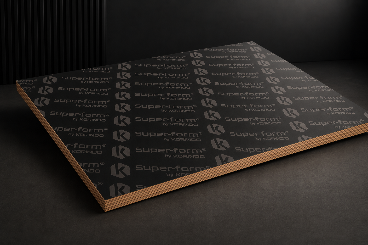 Super-form® by Korindo film faced plywood panel : close-up of branded dark phenolic surface and birch core edge.
